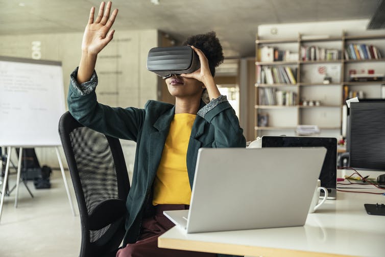 A woman wearing virtual reality goggles.