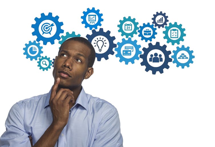 A man in a thinking pose with a finger to his chin, with icons of different thoughts in gears behind him