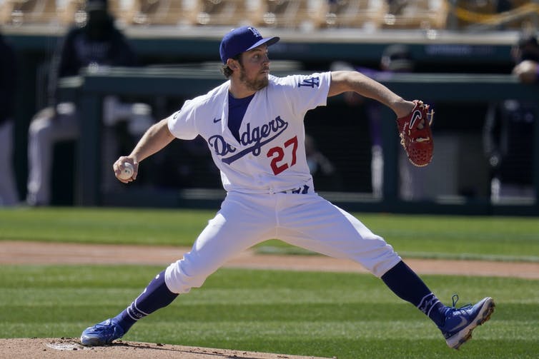 Pitcher Trevor Bauer is shown pitching in a game