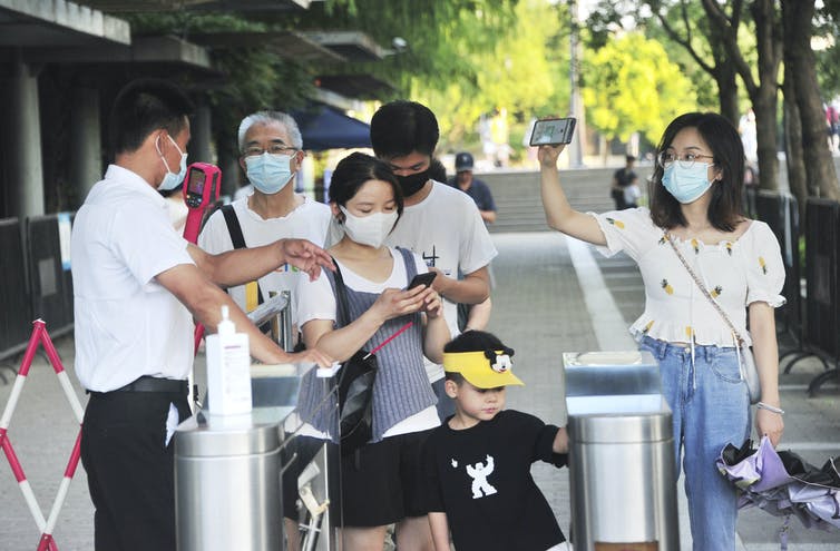 Staff checking people's green 'health codes'.