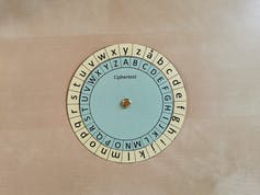 A paper wheel with different symbols sits on a desk. 