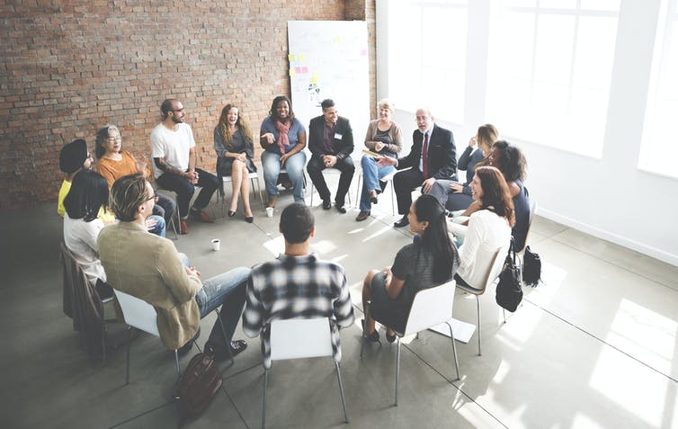 A group of people sitting in a circle.