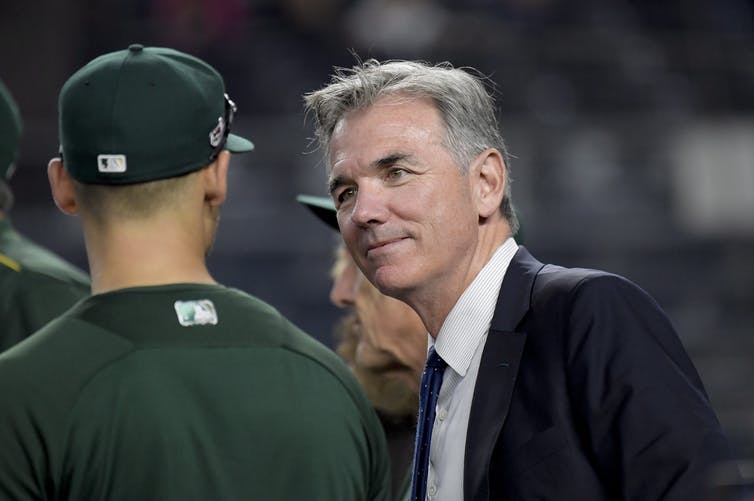 Billy Beane talks to one of the Oakland Athletics baseball players