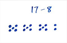 17 dots arranged into clusters of three fives and a two.