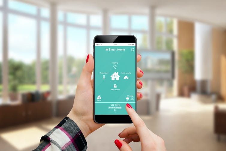 Woman using a smarthome app on her phone.