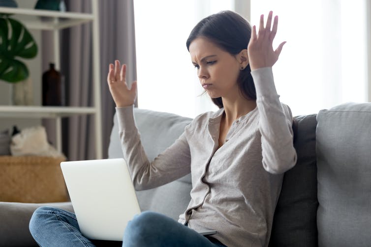 Woman on sofa angry with laptop