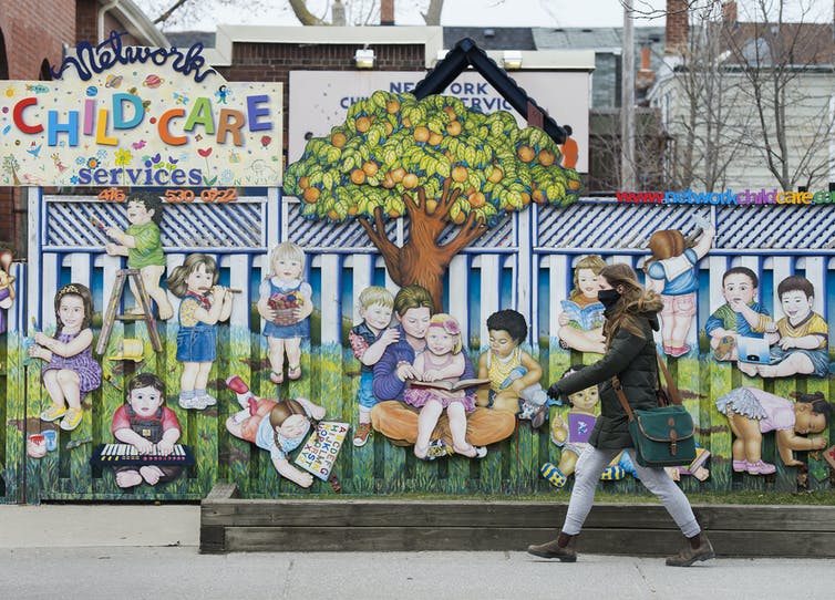 A woman passes a closed day care.