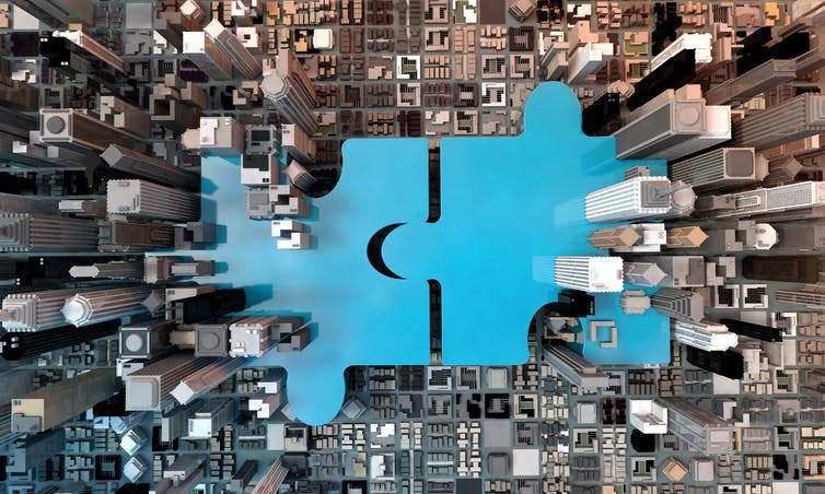 blue puzzle pieces, aerial view of city skyscrapers