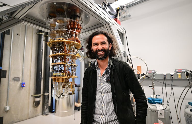 A man stands by a quantum computer in California