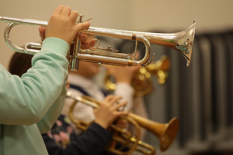 Children playing the trumpet.