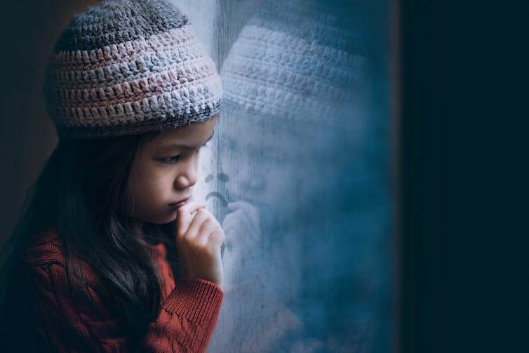 Sad girl looking out of window