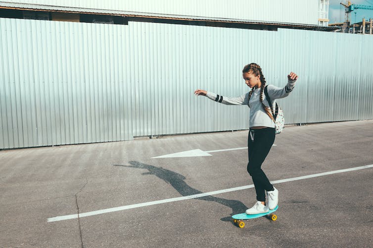 Young girl on a skateboard.