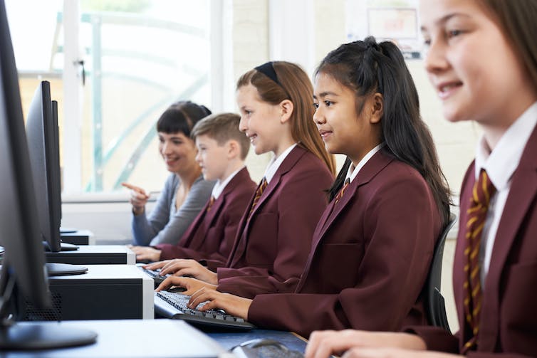 Pupils in uniform in computer lab