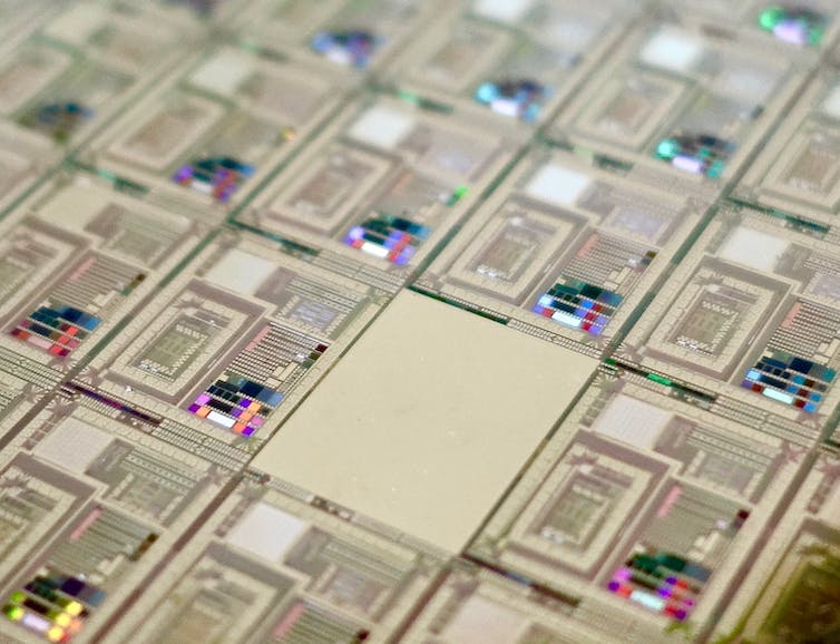 close-up of a computer chip showing colored LEDs scattered among integrated circuits