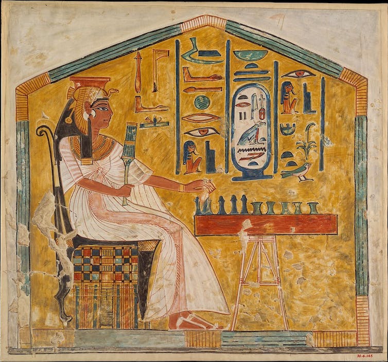 A tomb illustration showing Queen Nefertari sat and playing the board game, Senet.