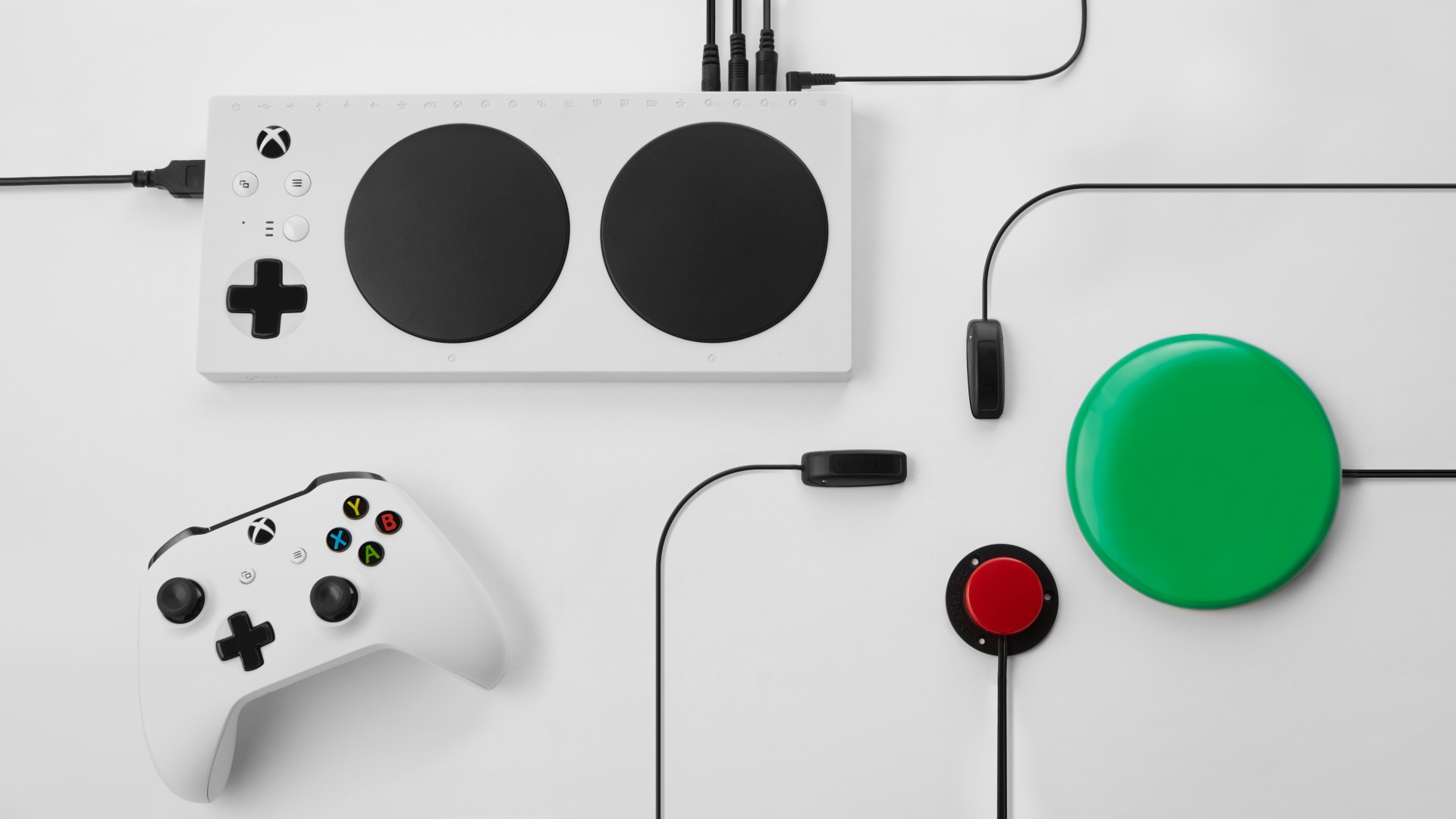 Image of an Xbox Adaptive Controller set-up, complete with a controller and other outputs.