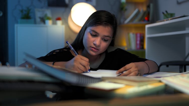 Girl revising for exams in room