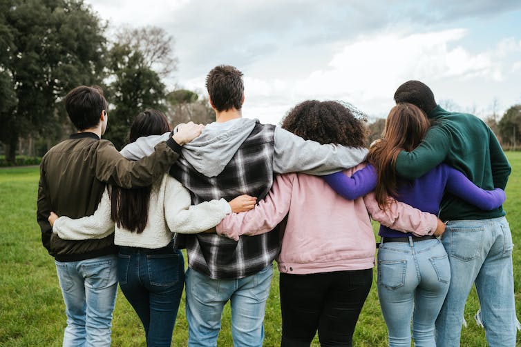 Group of friends seen from behind in park