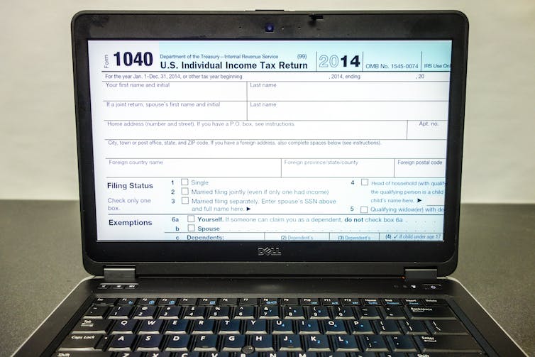 A 2014 1040 U.S. tax form displayed on a laptop