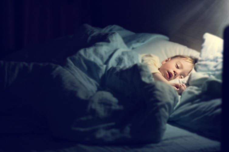 Sleeping toddler in dark room