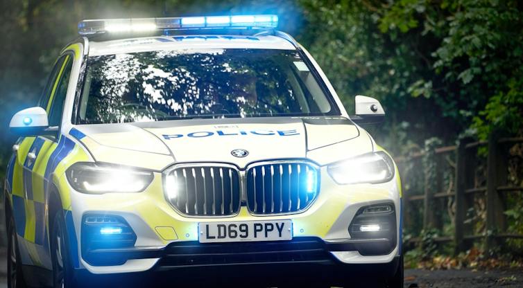 A police car with blue lights flashing.