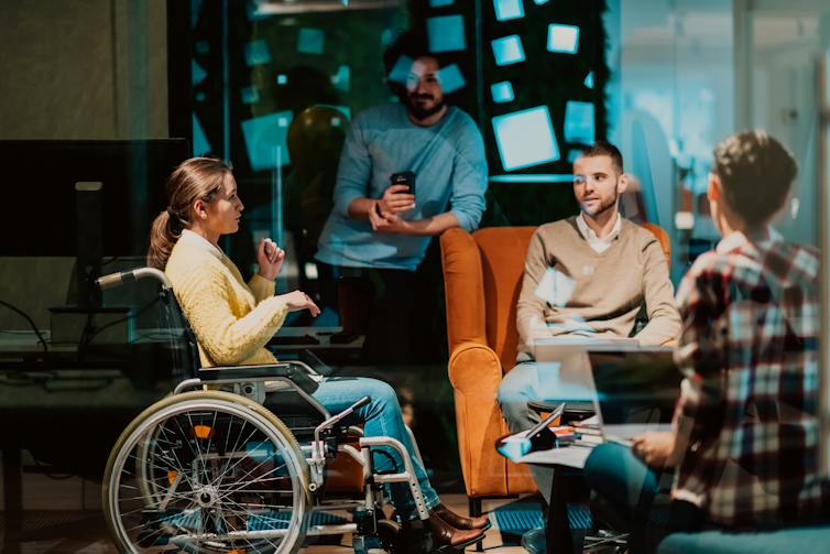 Woman in wheelchair in casual meeting