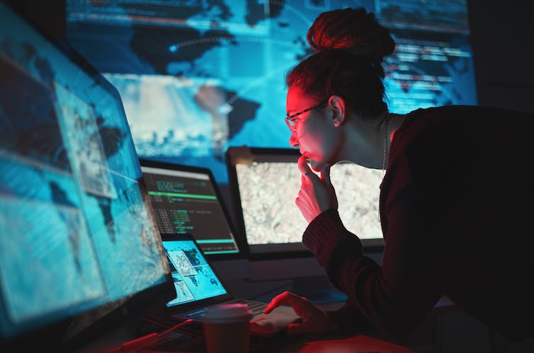 Person looking at computer screens.