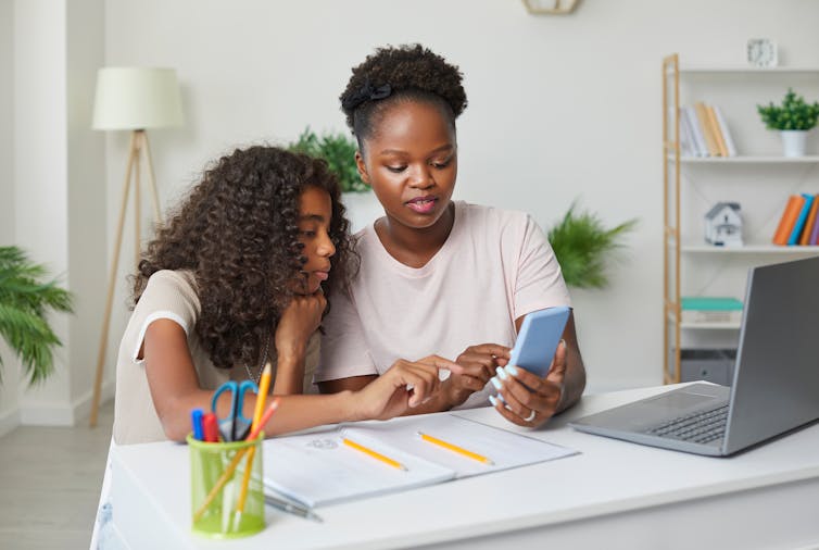 Mother and daughter looking at phone