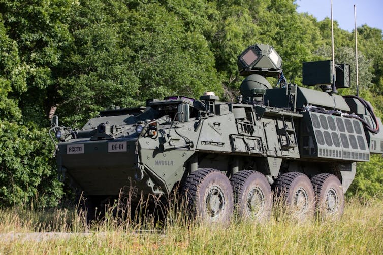 an eight-wheeled military vehicle with a spherical device mounted on top