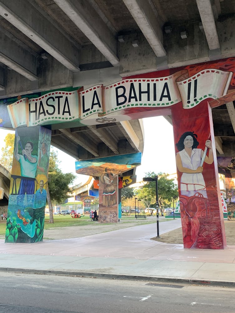 Painted murals on the support pillars of an overhead motorway.