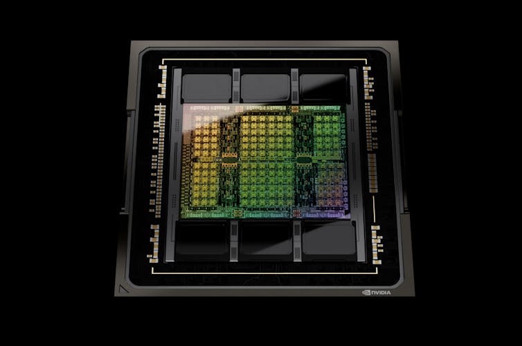 A photo of an iridescent computer chip against a black background.