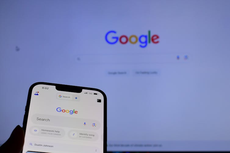 a phone and computer screen both showing the Google search bar