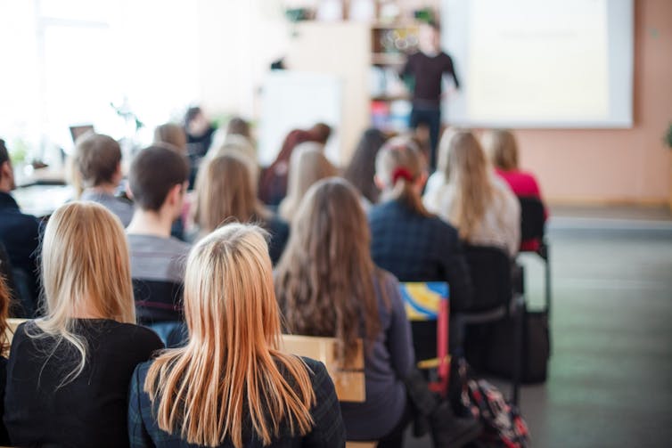 Students listen to a lecturer in class