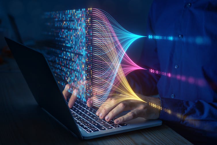 a laptop with rows of multicoloured information hovering above the keyboard