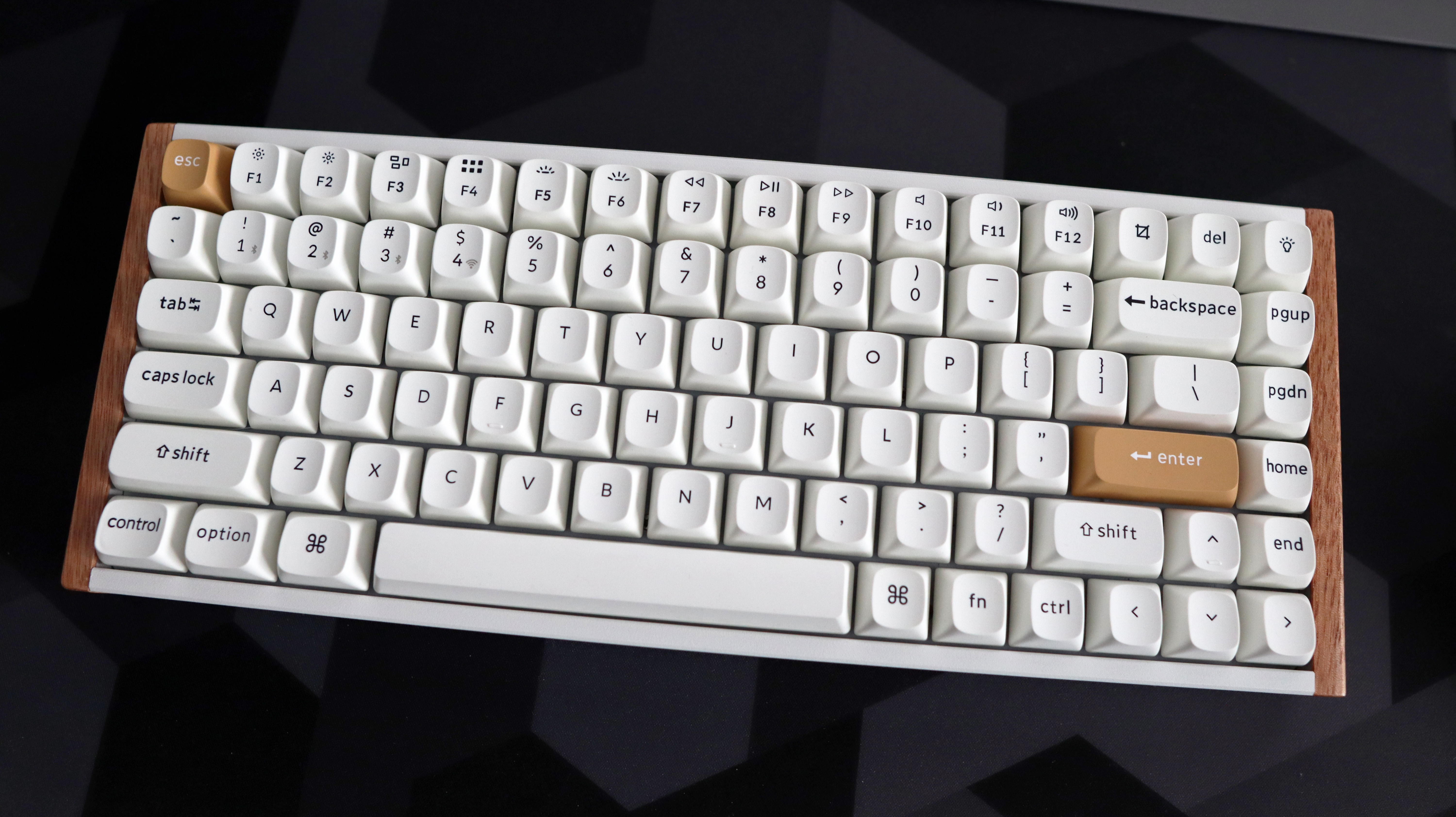 A Keychron K2 HE gaming keyboard with a wood finish and white keycaps with RGB enabled.