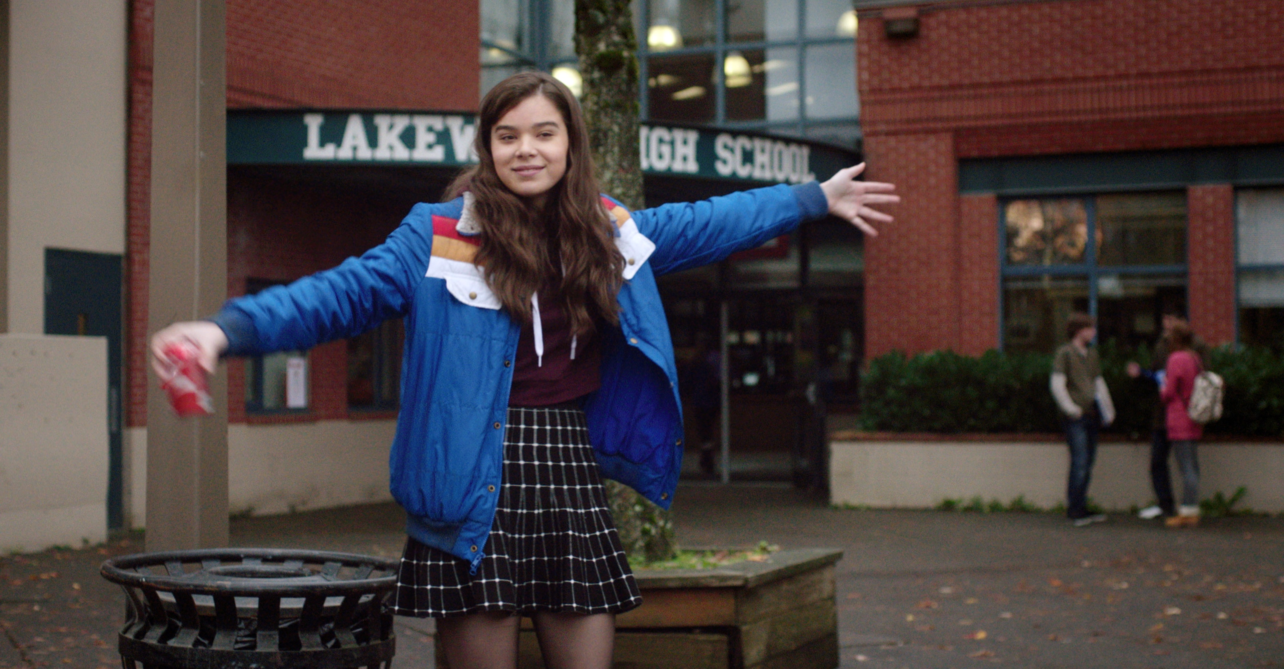 Hailee Steinfeld as Nadine in The Edge of Seventeen, holding a soda can and wearing a bright blue jacket 