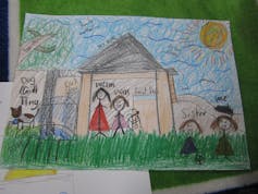 Colourful drawing of a family standing in the sunshine in front of their home with their pet dog, beneath a large tree.