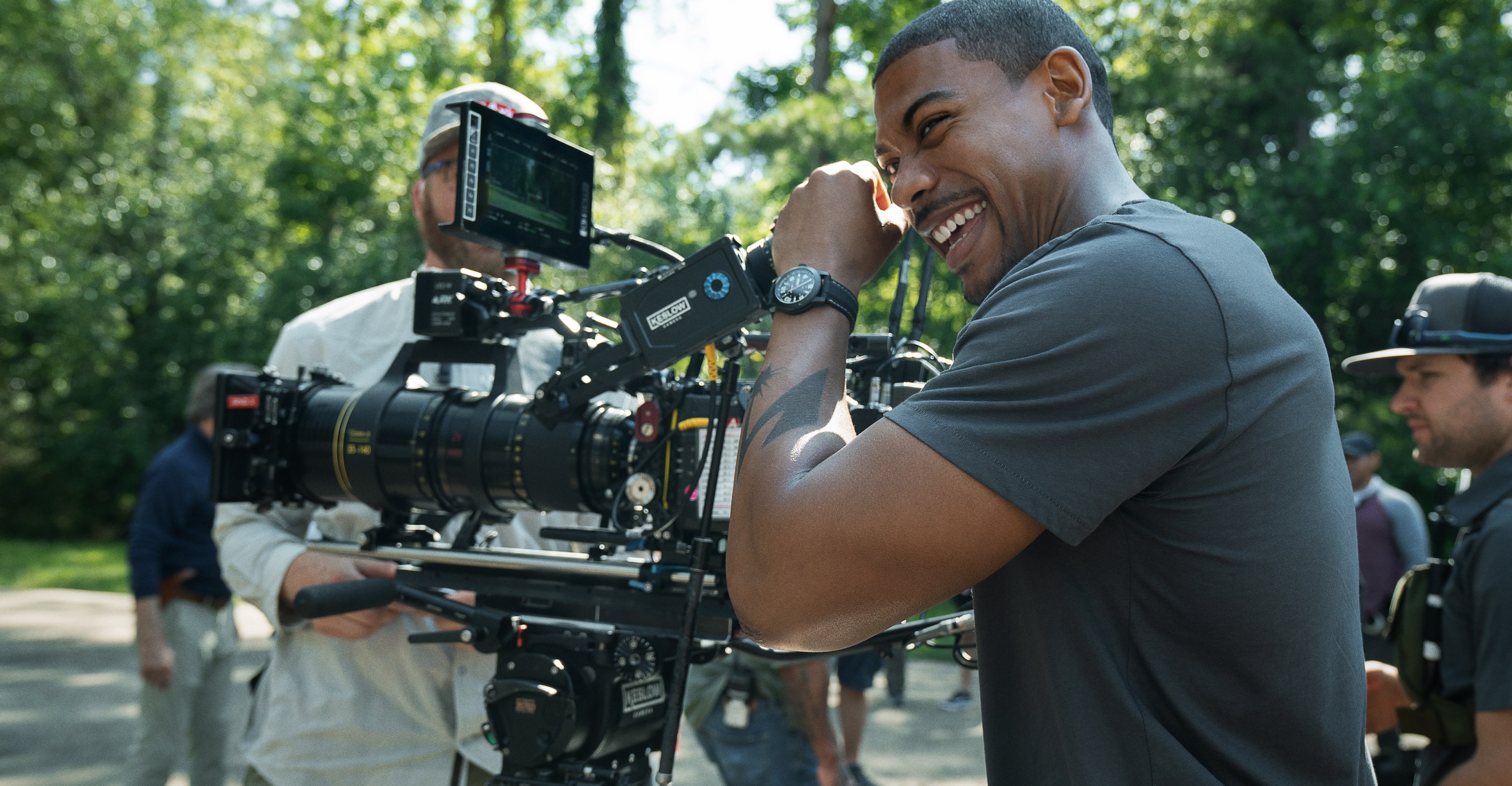 Star Aaron Pierre laughs as he cups the eyepiece of one of the cameras on the set of Jeremy Saulnier’s Netflix movie Rebel Ridge