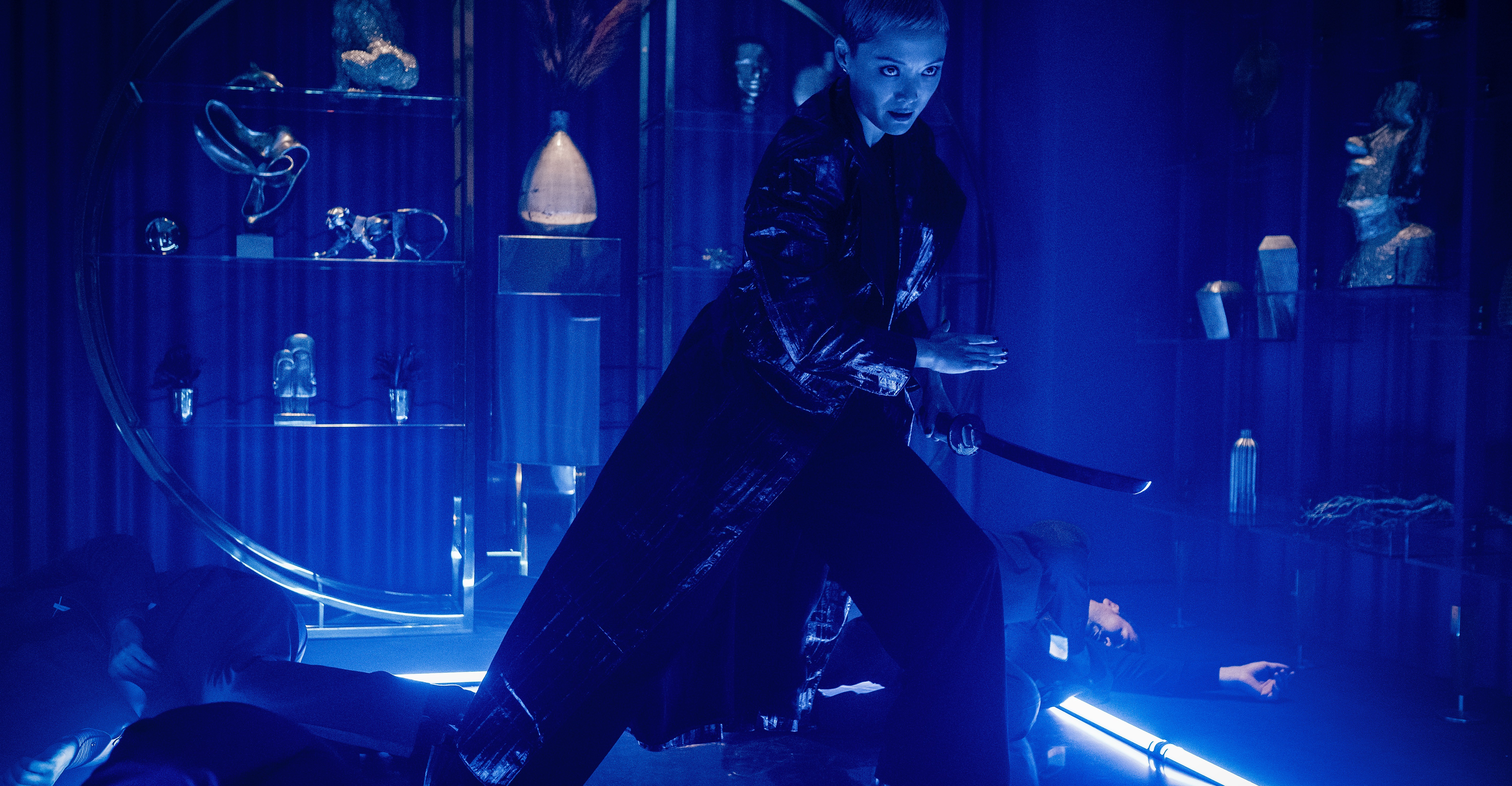 Pom Klementieff looking badass as hell with a sword in blue lighting in The Killer’s Game