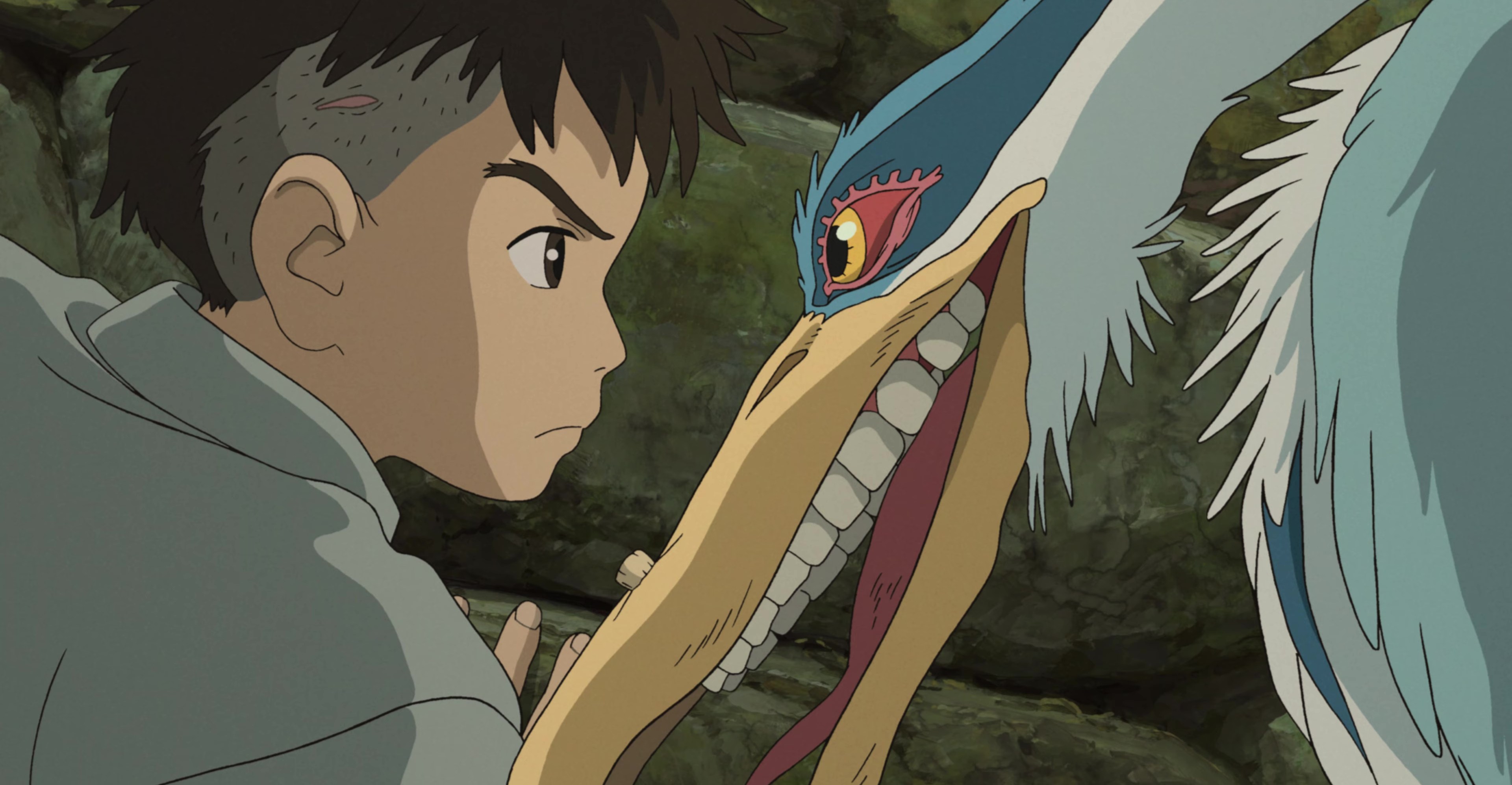 A boy with a visible scar on his head stares sternly at a leering bird with visible teeth in The Boy and the Heron.