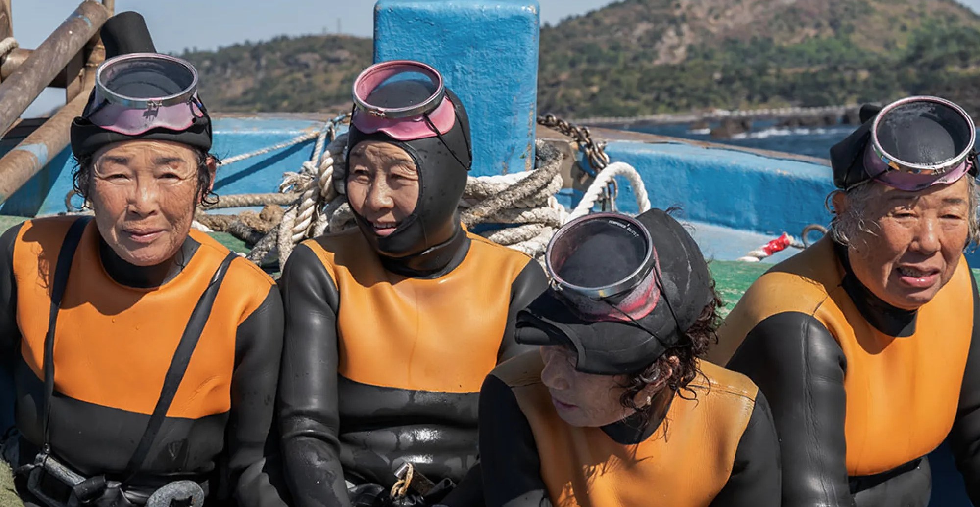 Four women in scuba suits in The Last of the Sea Women.