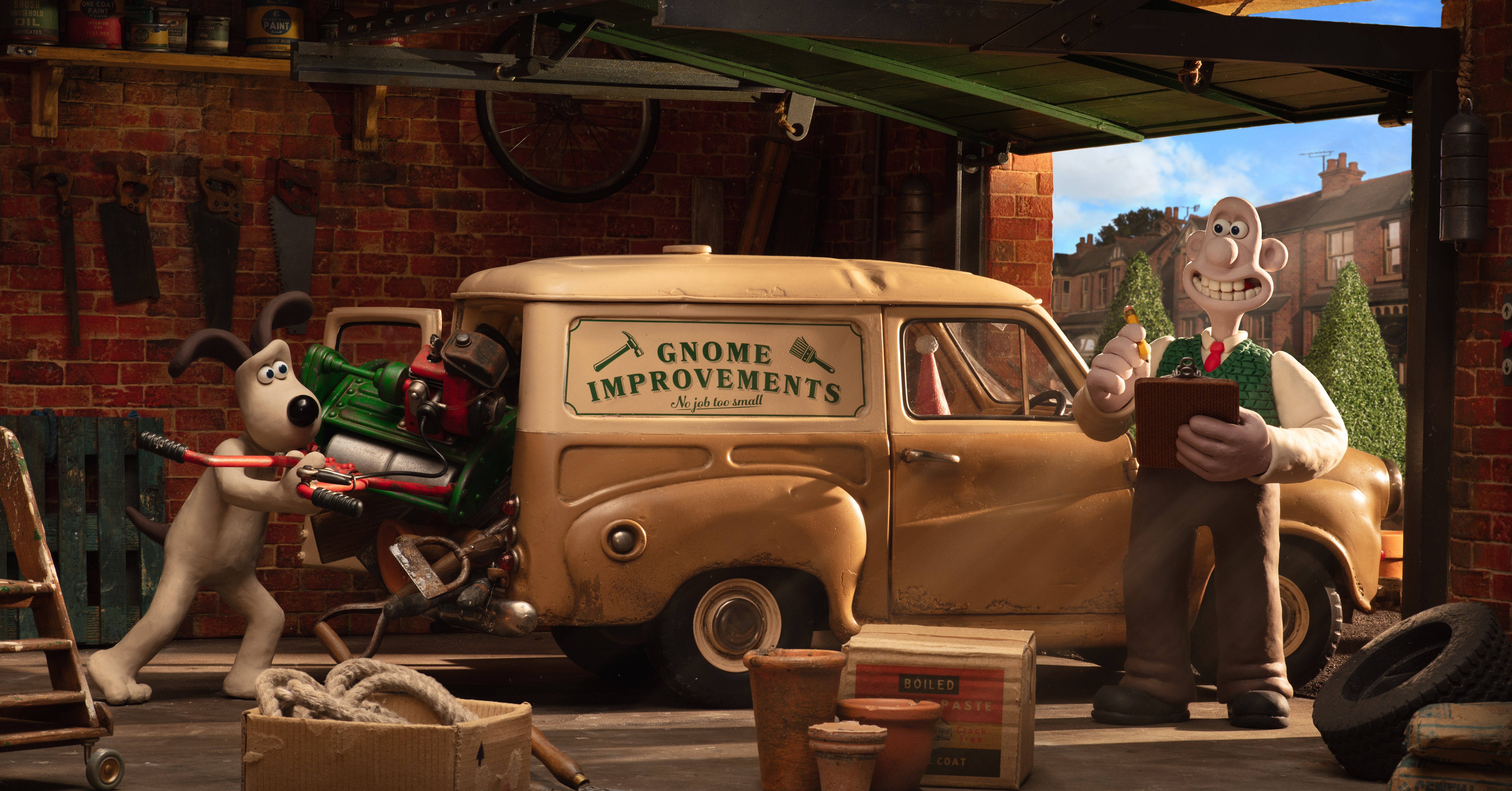 Gromit pushes a gas-powered machine into a van with the words “Gnome Improvements” printed on the side as Wallace examines his clipboard